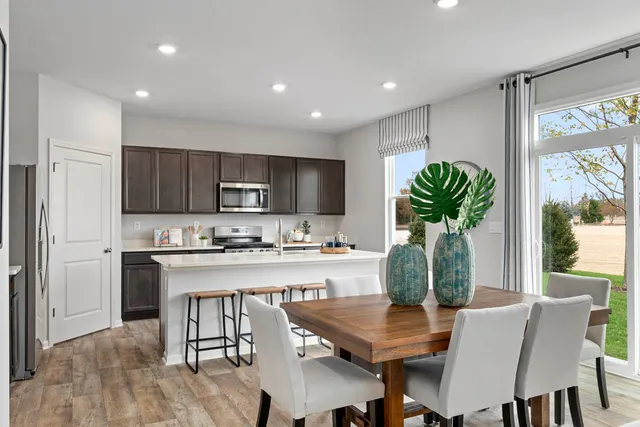 a view of kitchen with microwave stove and refrigerator