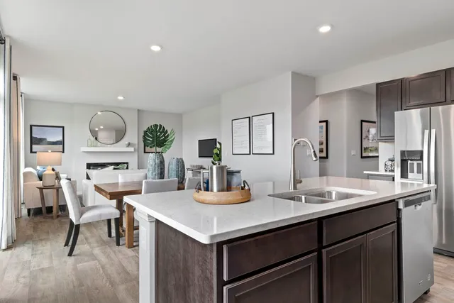 a kitchen with a dining table chairs and white cabinets