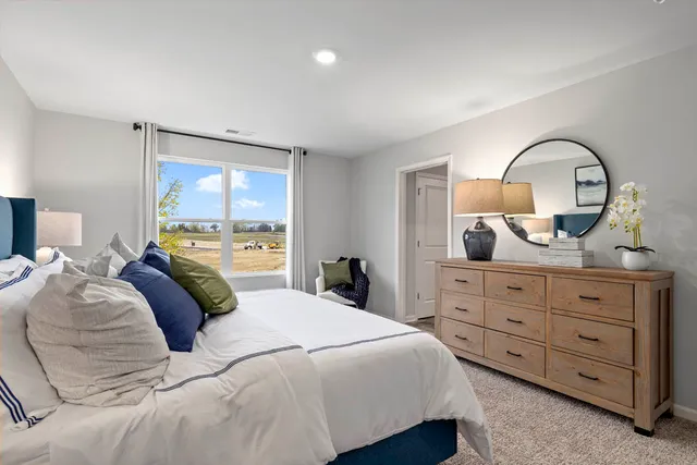 a bedroom with a bed and a large window