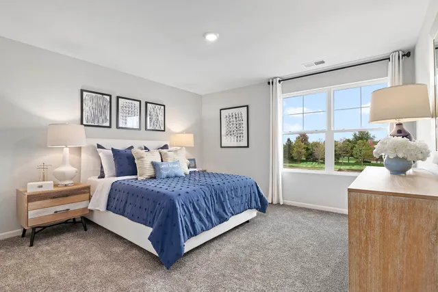 a spacious bedroom with a bed and a window