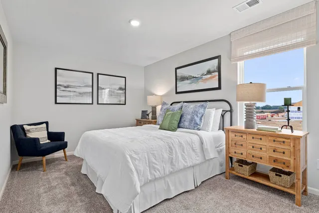 a bedroom with a bed and a couch