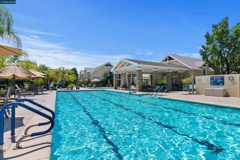 a view of a patio with couches table and chairs and potted plants