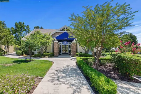 a view of a backyard with table and chairs under an umbrella