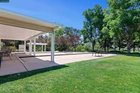 a house view with a sitting space and garden
