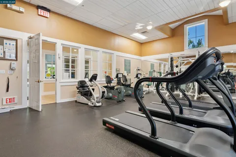 a view of patio with table and chairs under an umbrella