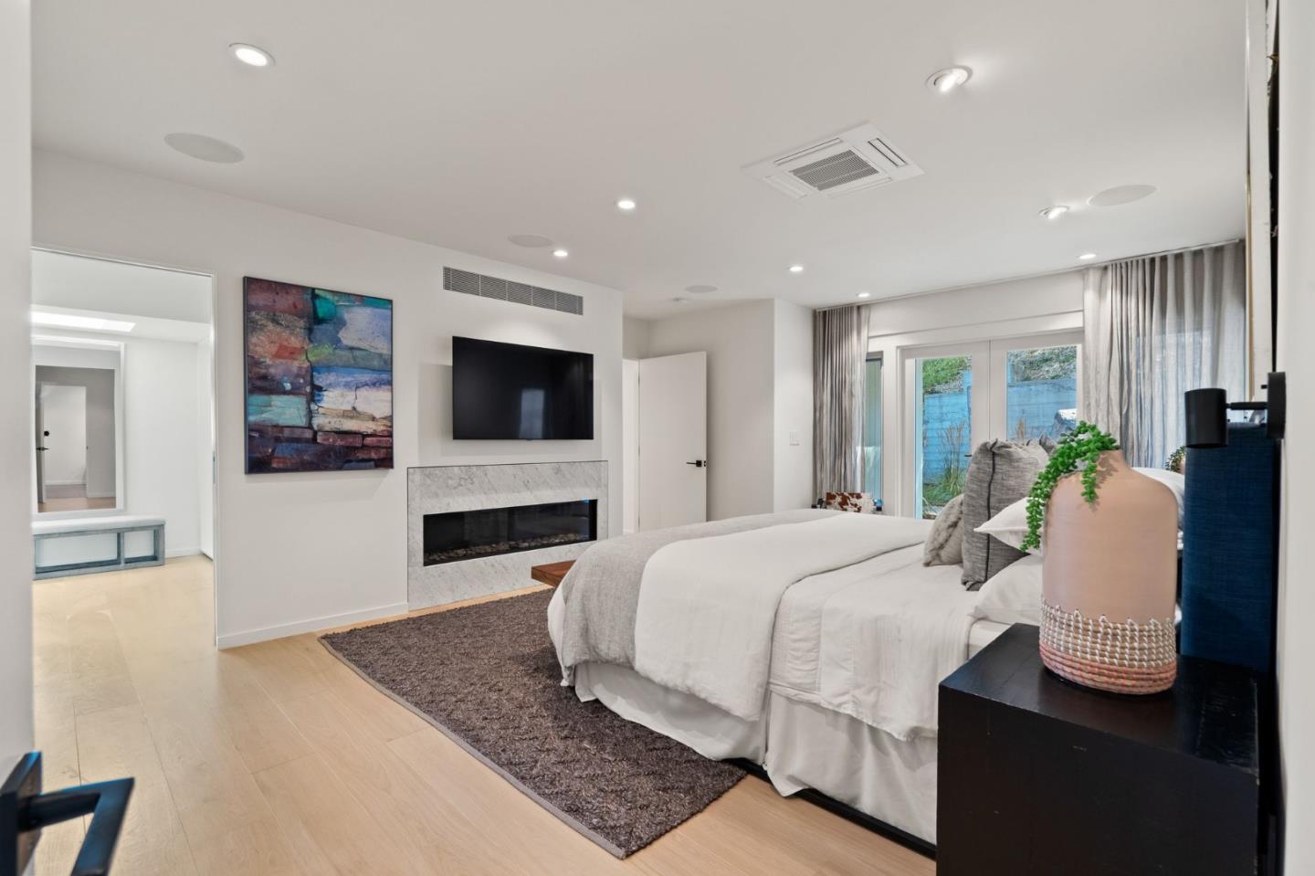 161 Eleanor Drive Woodside, CA 94062 - Photo 16 of 57 a bedroom with a bed and glass wall