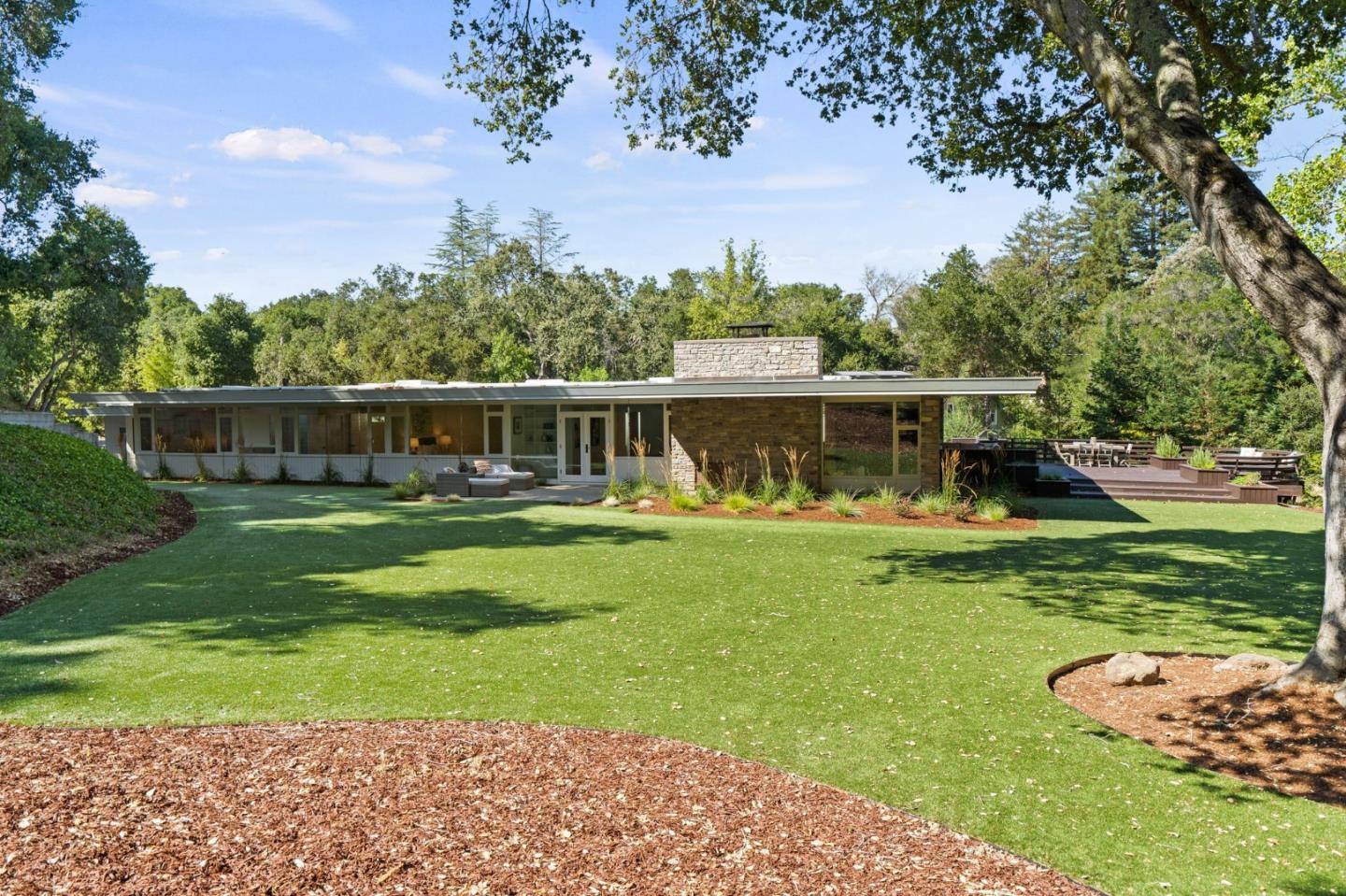 161 Eleanor Drive Woodside, CA 94062 - Photo 3 of 57 a front view of a house with a yard table and chairs