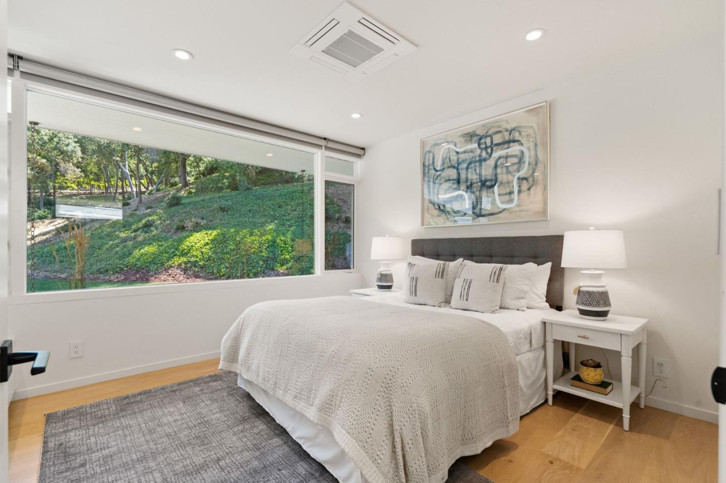161 Eleanor Drive Woodside, CA 94062 - Photo 40 of 57 a bedroom with a bed painting on wall and a large window