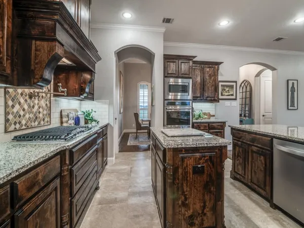 a kitchen with stainless steel appliances granite countertop a stove and a sink