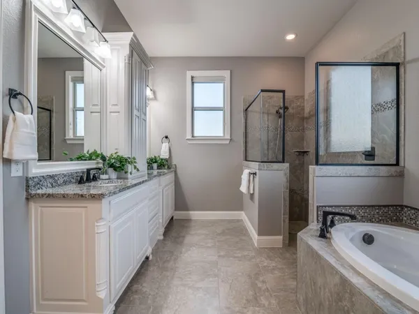 a bathroom with a granite countertop sink a toilet and shower