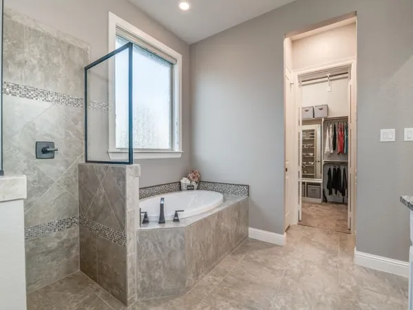 a bathroom with a tub and a sink