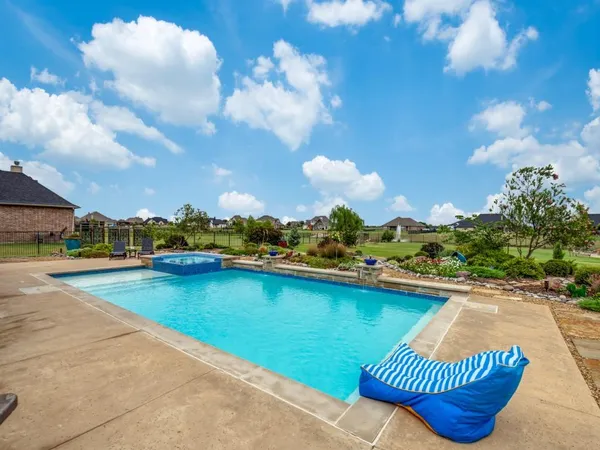a view of swimming pool outdoor seating and city view