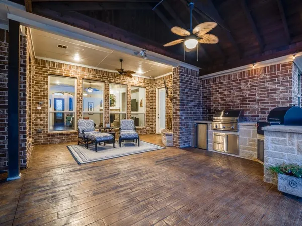 a living room with furniture a fireplace and a chandelier