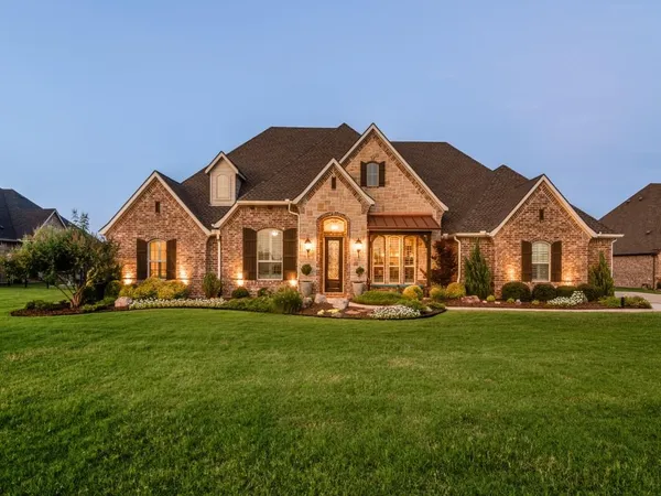a view of a house with a big yard and large trees