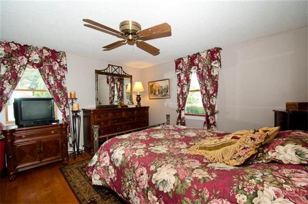 85 Maple Road Longmeadow, MA 01106 - Photo 7 of 30 a bedroom with a bed and a flat screen tv