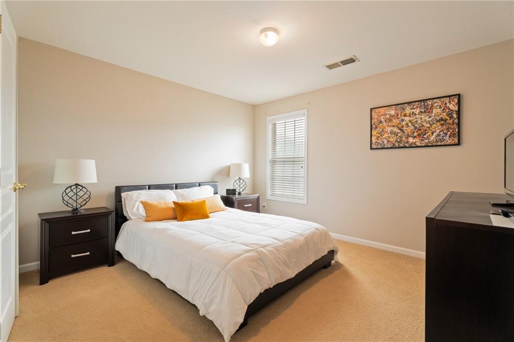 878 Scales Road Suwanee, GA 30024 - Photo 16 of 17 a bedroom with a bed and a night stand