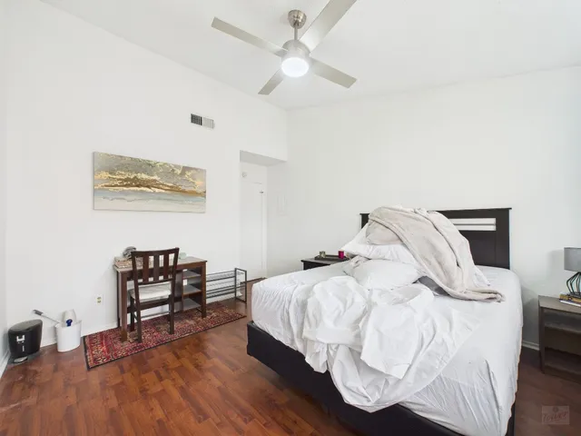 a bedroom with a bed and a chair