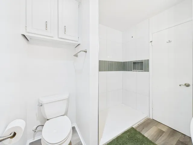 a bathroom with a toilet and a shower