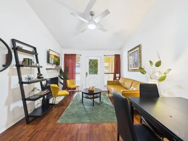 a living room with furniture and wooden floor