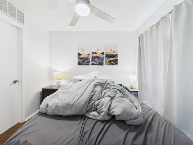 a bedroom with a bed and a window