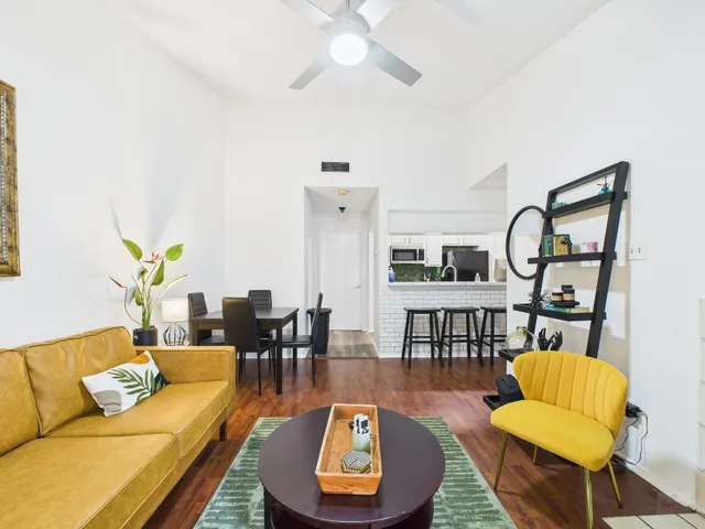 a living room with furniture a rug and a chandelier