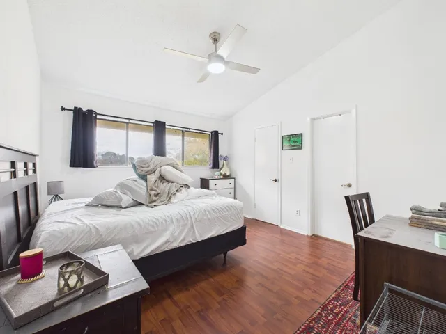 a bedroom with a bed and a table in it