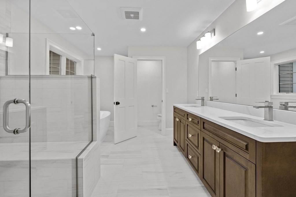 20 Harding Road Lexington, MA 02420 - Photo 14 of 41 a spacious bathroom with a double vanity sink a large mirror and shower