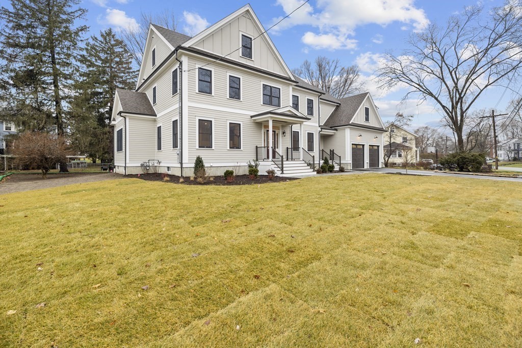 20 Harding Road Lexington, MA 02420 - Photo 35 of 41 a view of a white house with a large pool and lawn chairs under an umbrella