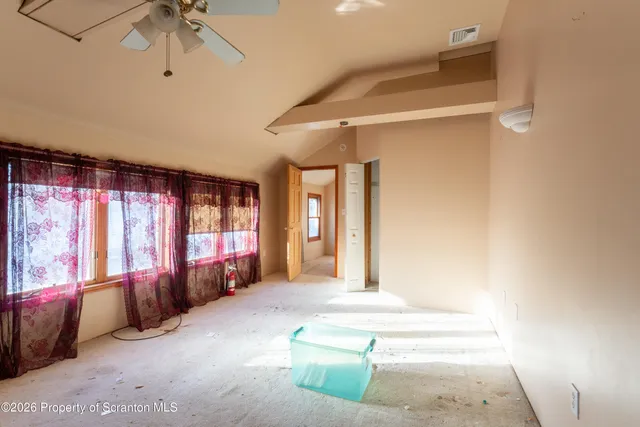 a living room with furniture and large windows