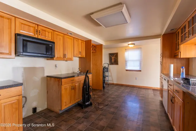 a kitchen with stainless steel appliances granite countertop a refrigerator a stove top oven a sink and dishwasher