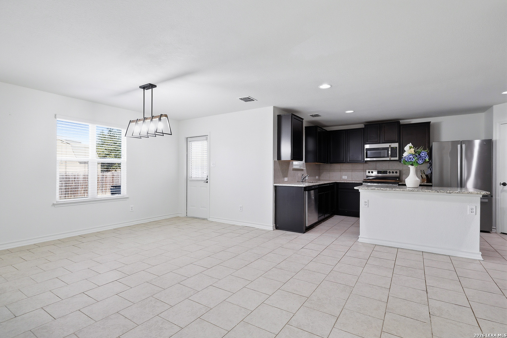 7435 Rigel Chase San Antonio, TX 78252 - Photo 12 of 38 a kitchen with stainless steel appliances a refrigerator sink and microwave