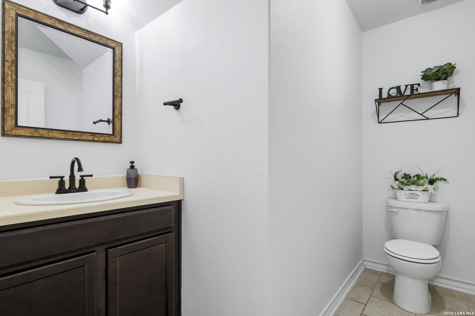 7435 Rigel Chase San Antonio, TX 78252 - Photo 13 of 38 a bathroom with a toilet sink vanity and mirror