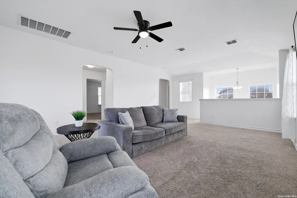 a living room with furniture and kitchen view