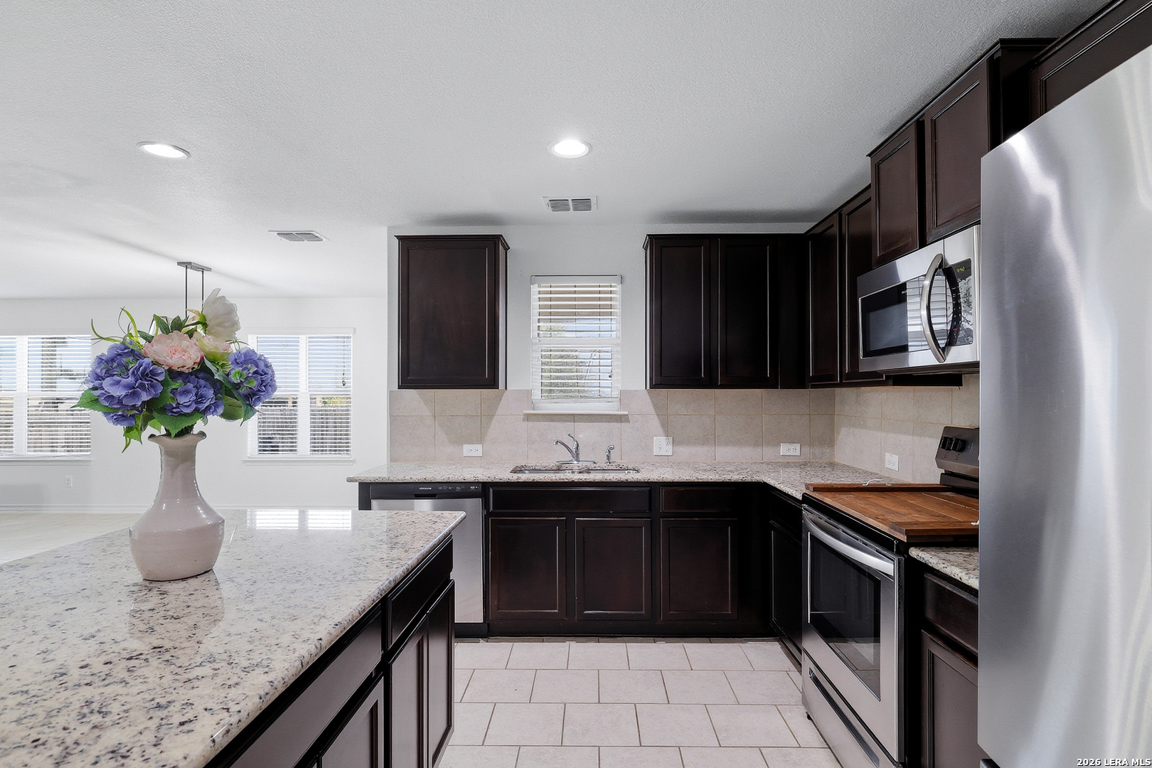 7435 Rigel Chase San Antonio, TX 78252 - Photo 19 of 38 a kitchen with a sink dishwasher and a refrigerator
