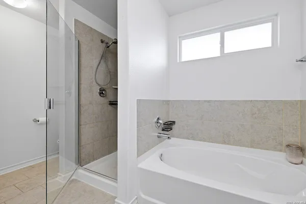 a bathroom with a bathtub and shower