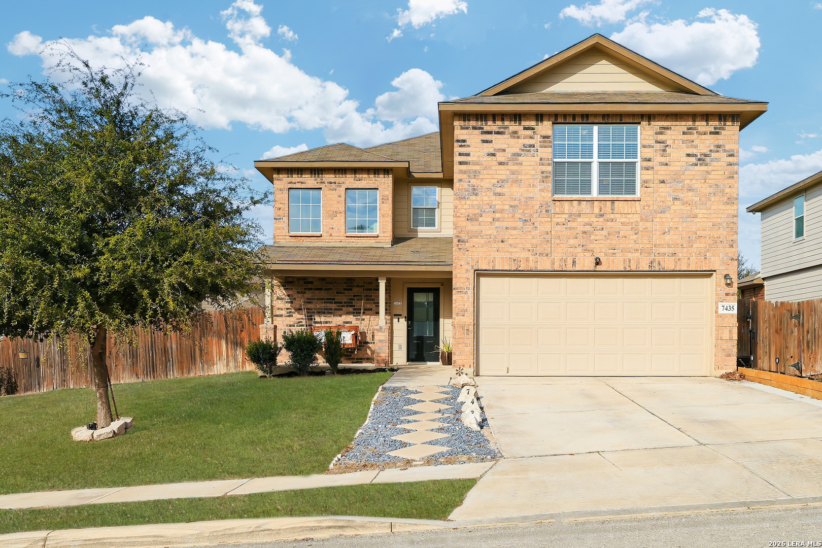 7435 Rigel Chase San Antonio, TX 78252 - Photo 2 of 38 a front view of a house with a garden