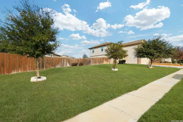 a view of a house with a backyard