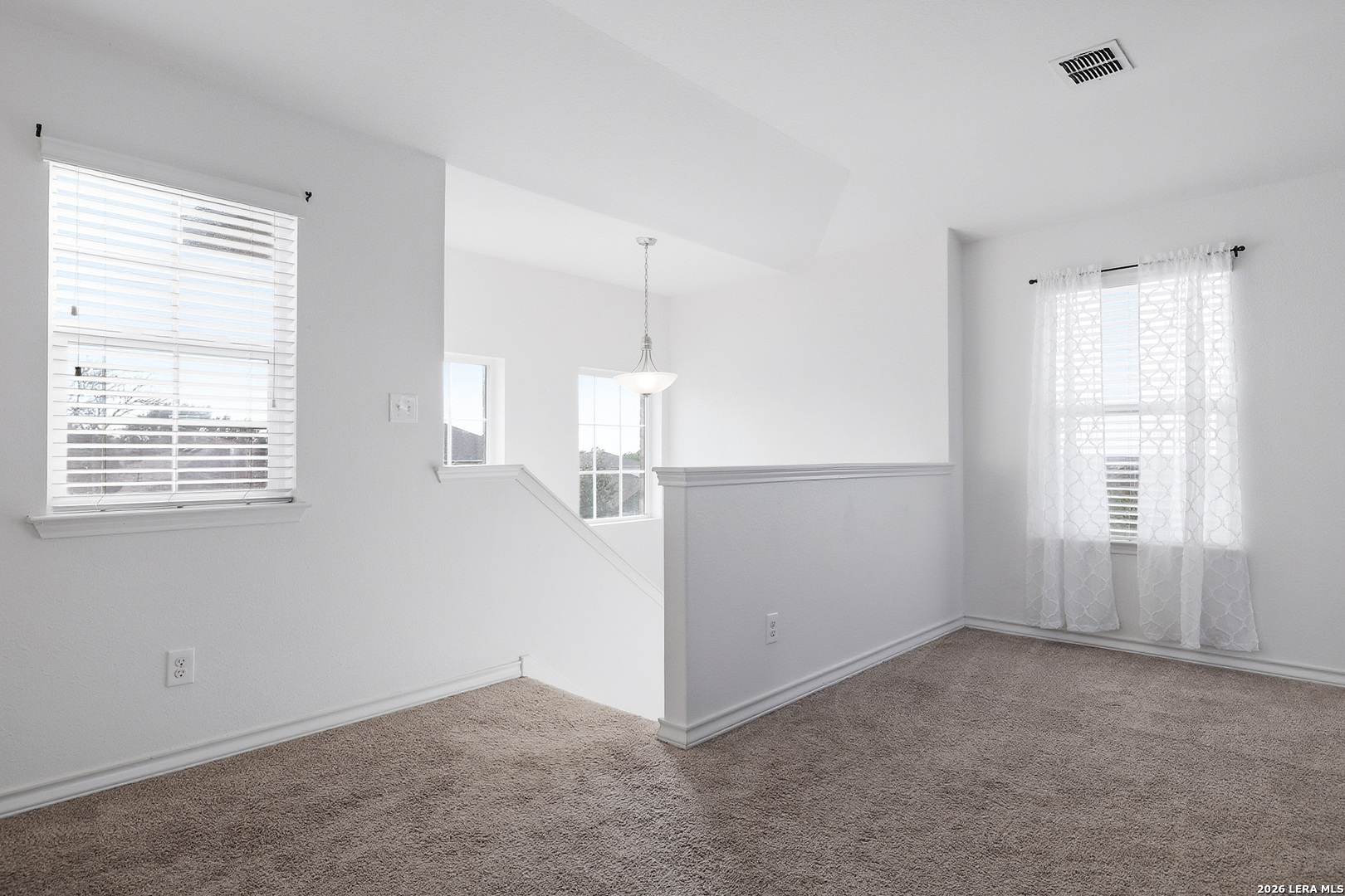 7435 Rigel Chase San Antonio, TX 78252 - Photo 21 of 38 an empty room with windows and cabinet