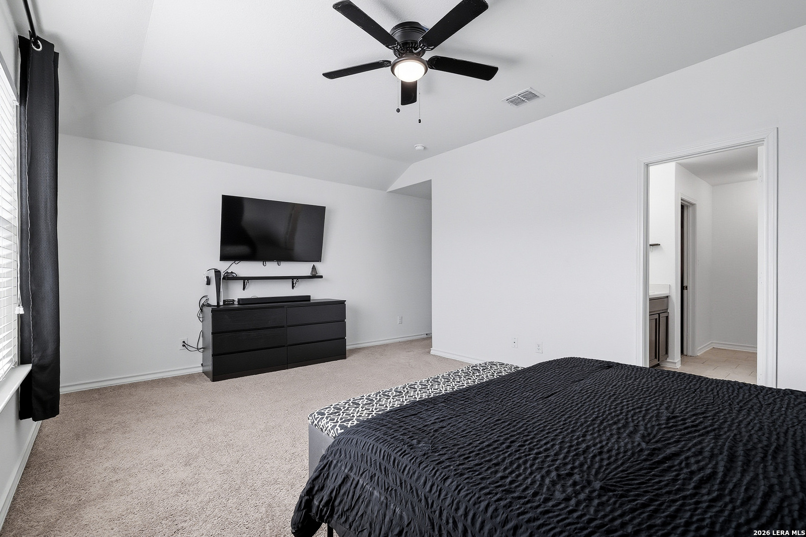 7435 Rigel Chase San Antonio, TX 78252 - Photo 22 of 38 a bedroom with a bed and a flat screen tv