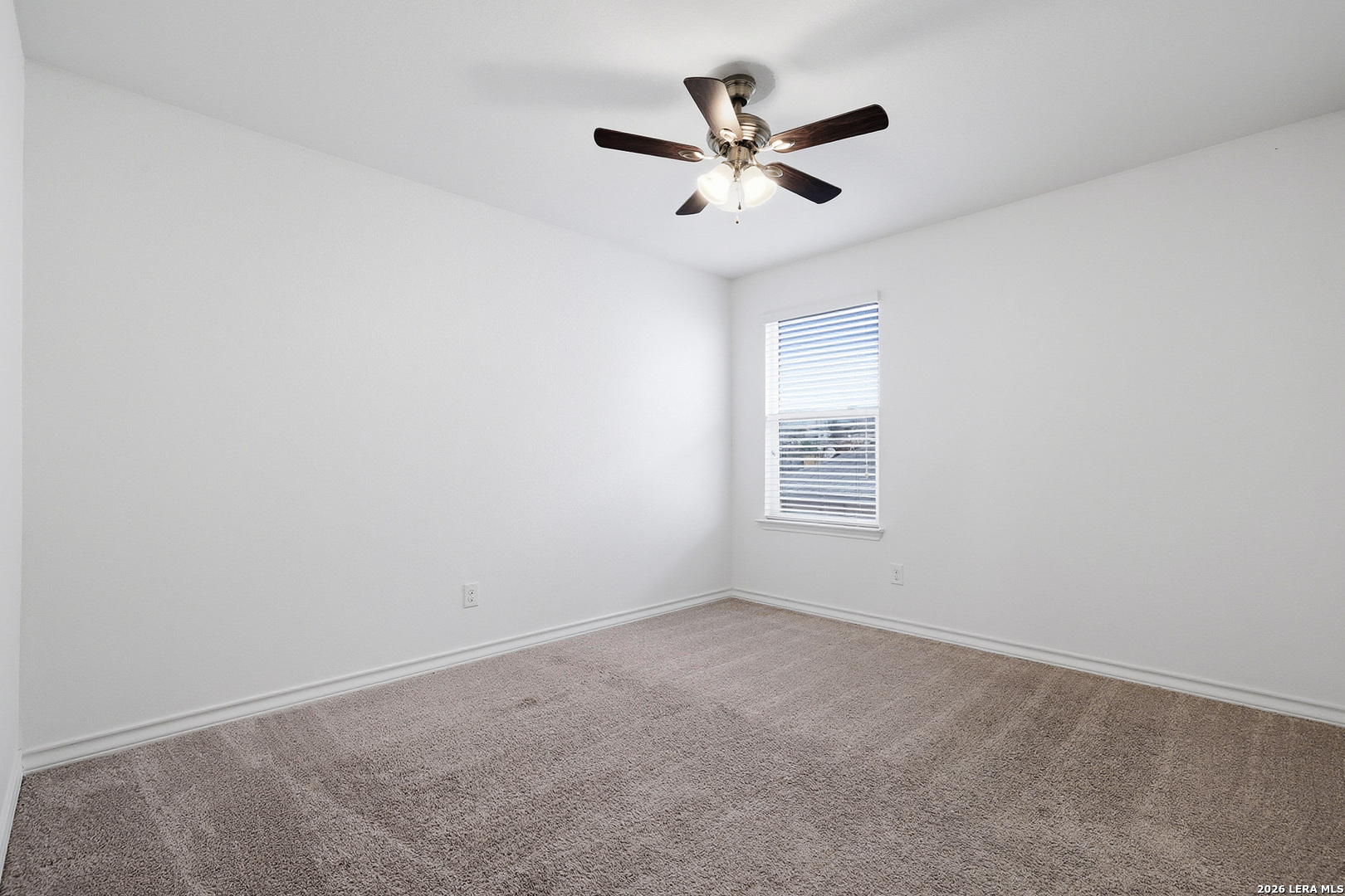7435 Rigel Chase San Antonio, TX 78252 - Photo 30 of 38 an empty room with a window and a fan