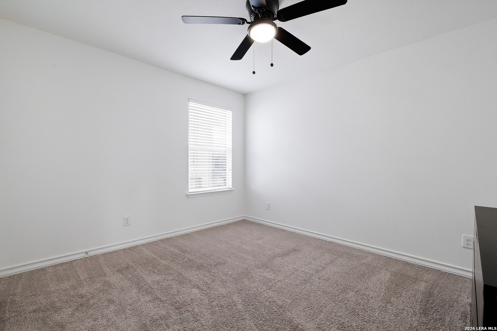 7435 Rigel Chase San Antonio, TX 78252 - Photo 32 of 38 an empty room with windows and fan