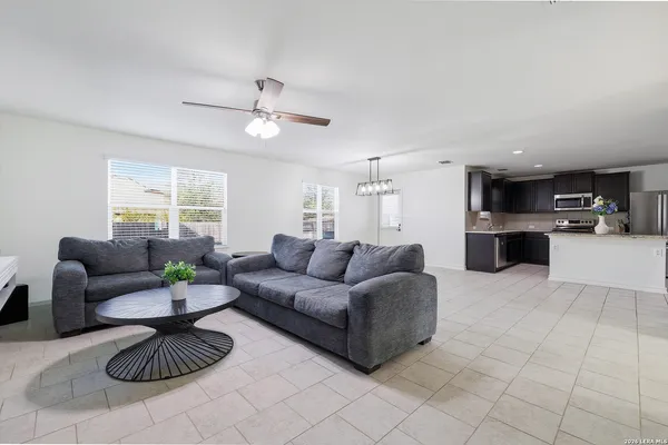 a living room with furniture a table and a potted plant