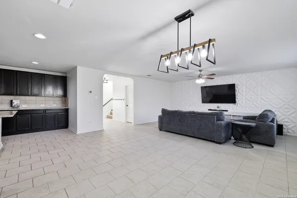a living room with furniture and kitchen view