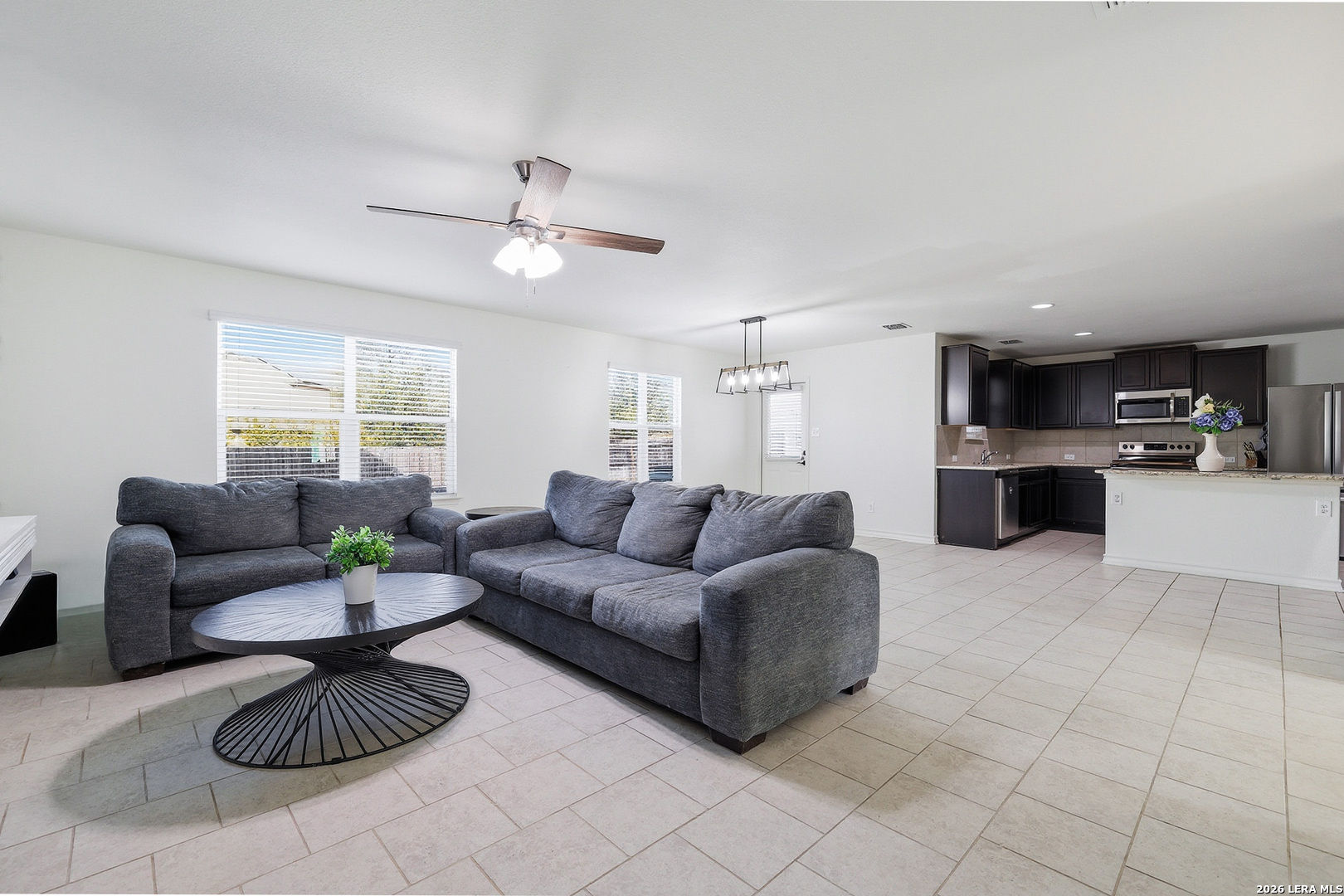 7435 Rigel Chase San Antonio, TX 78252 - Photo 10 of 38 a living room with furniture a table and a potted plant