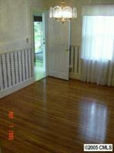 1210 Norland Road Charlotte, NC 28205 - Photo 3 of 8 a view of a hallway with wooden floor