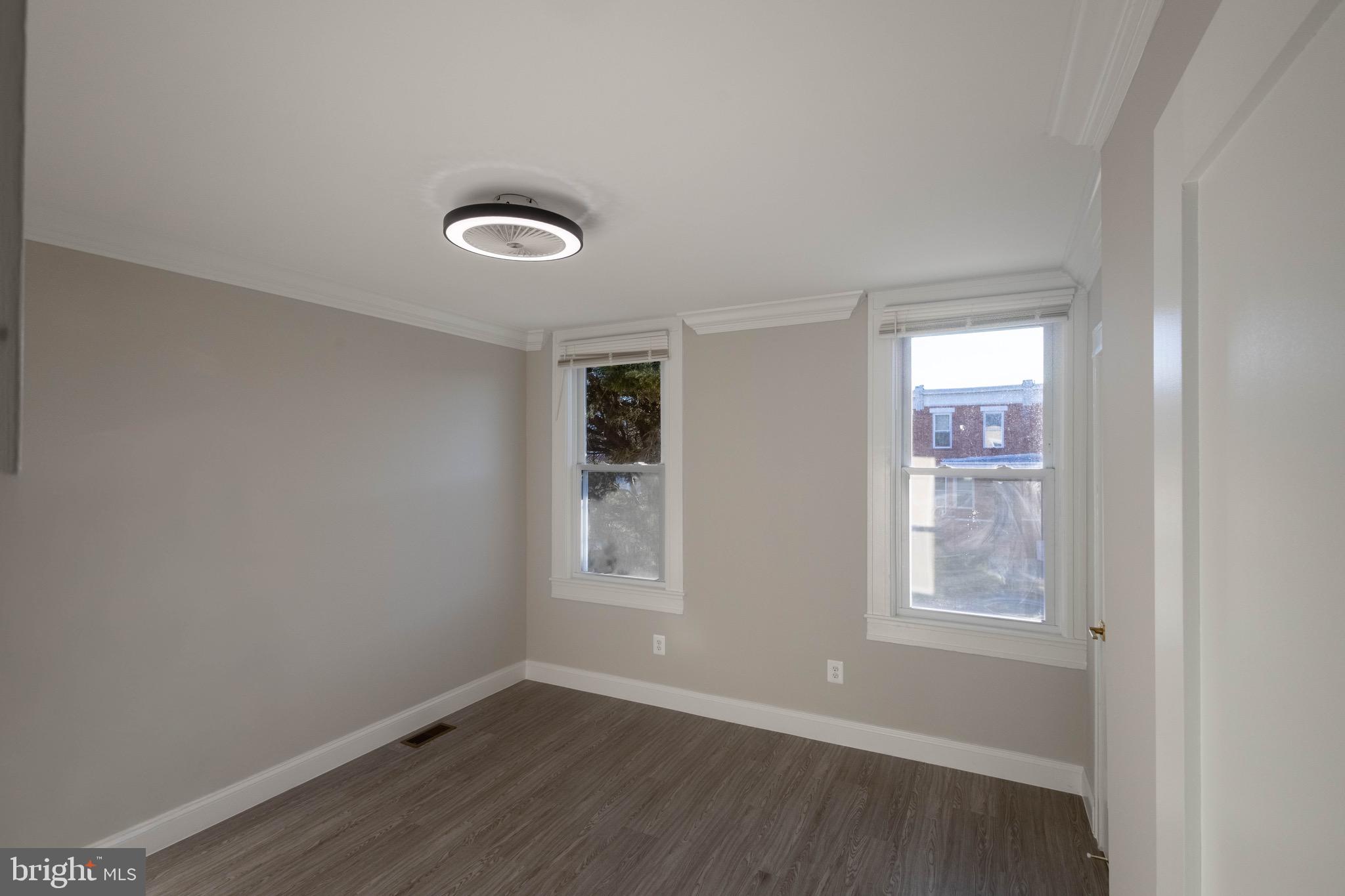 2846 Lake Avenue Baltimore, MD 21213 - Photo 12 of 28 an empty room with windows and mirror