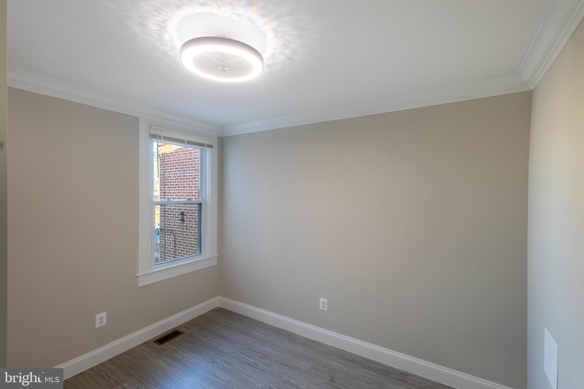 2846 Lake Avenue Baltimore, MD 21213 - Photo 14 of 28 an empty room with windows and closet