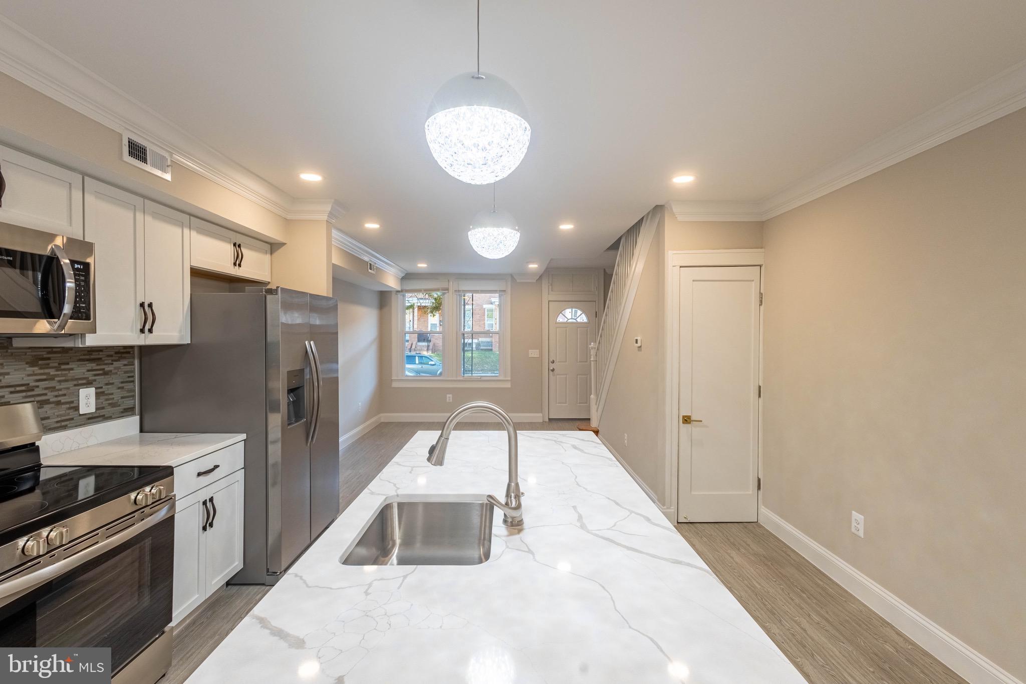 2846 Lake Avenue Baltimore, MD 21213 - Photo 3 of 28 a view of a kitchen with a sink stainless steel appliances and cabinets