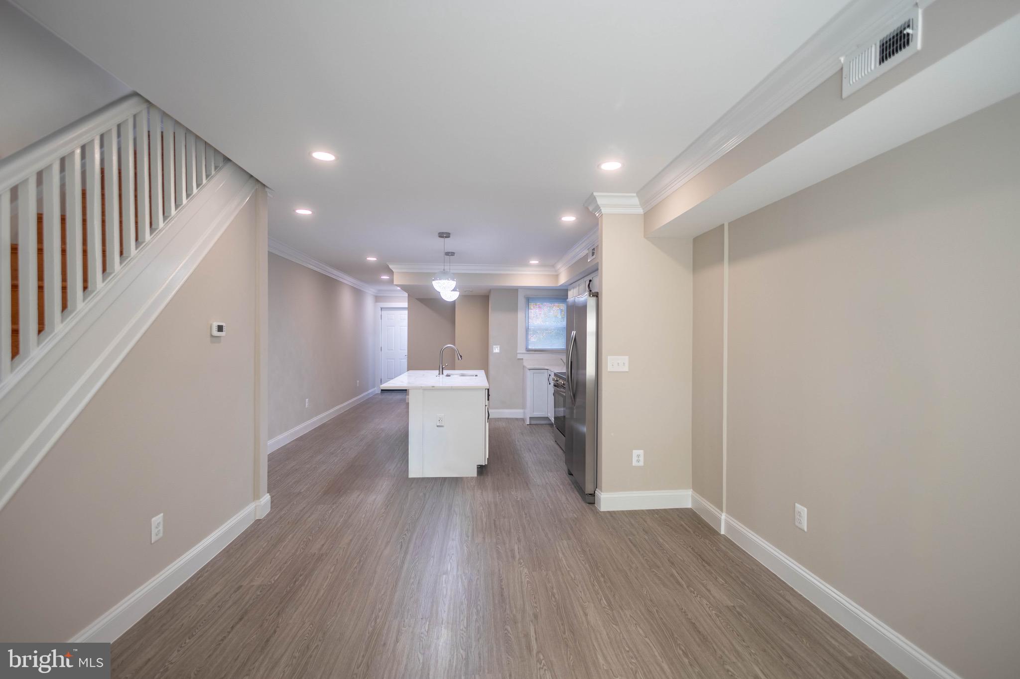 2846 Lake Avenue Baltimore, MD 21213 - Photo 7 of 28 a view of a room with wooden floor and a front door