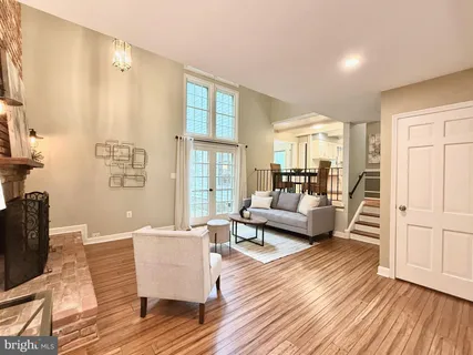 a living room with furniture and a hard wood floor